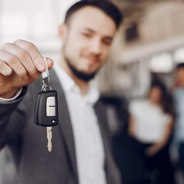 Man buying the car. Businessman in a car salon